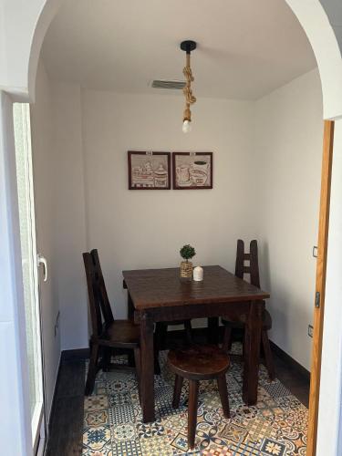 a dining room with a wooden table and chairs at Casa Emma in Burriana