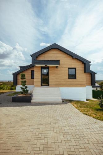 a wooden house with a black roof at Vila Pogled in Vrdnik