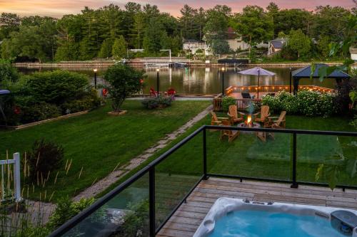 a view of a backyard with a hot tub at Charming riverside cottage, walk to beach in Wasaga Beach