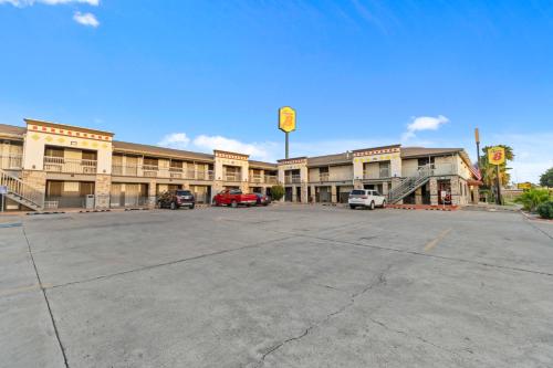 an empty parking lot in front of a building at Super 8 by Wyndham McAllen-Downtown-Airport-LA Plaza Mall in McAllen