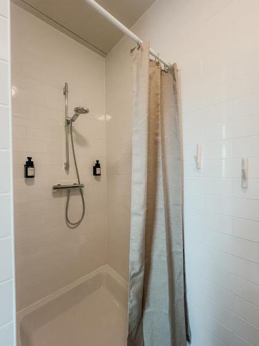a bathroom with a shower with a shower curtain at RetreatBoat Ibiza in Lith