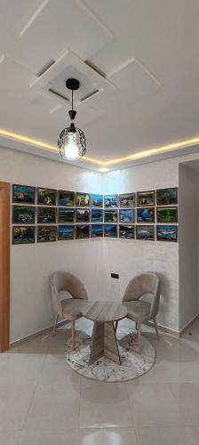 a dining room with a table and two chairs at La Maison Attawba in Beni Mellal