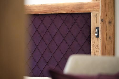 a purple door with a diamond pattern on it at Hotel Bergkristall in Silbertal