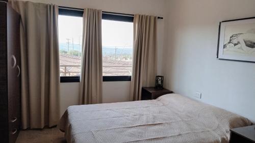 Ένα ή περισσότερα κρεβάτια σε δωμάτιο στο Apart Sierras Tanti