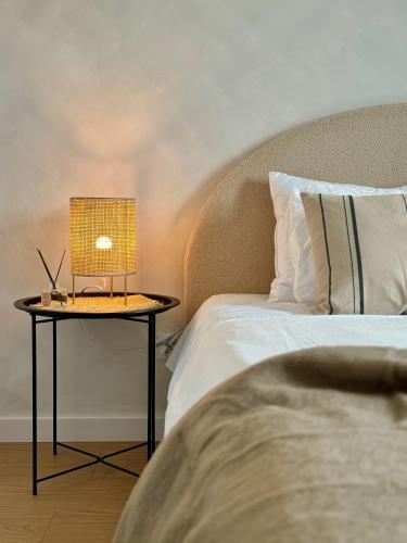 a bed with a table with a lamp on it at Apartament Premium No 5 - Faktura VAT - Targi Kielce - Parking - Blisko Terenów Zielonych - NEW in Kielce
