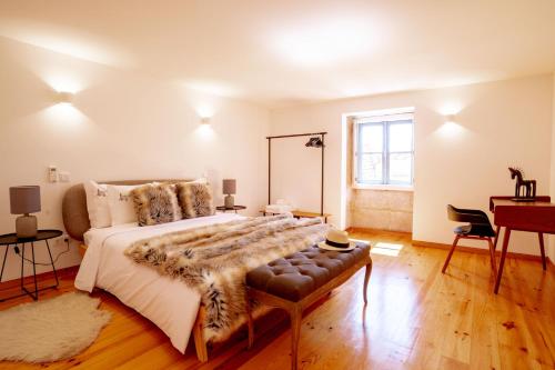 a bedroom with a large bed and a desk at Authentic Porto Village in Porto