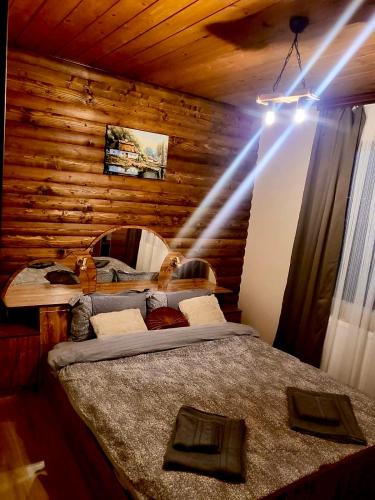 a bedroom with two beds in a room with wooden walls at Villa Capricorn in Tsigov Chark