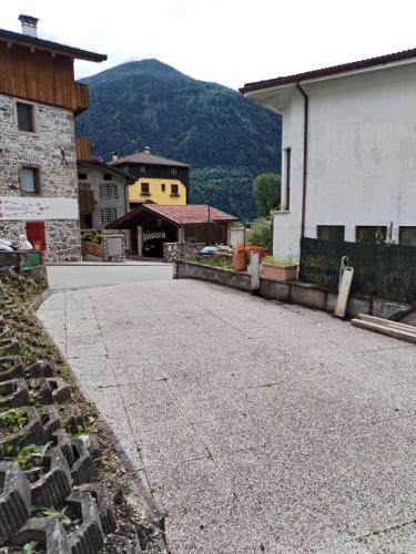 an empty street in a town with a mountain at Lûc dal Aur in Sùtrio