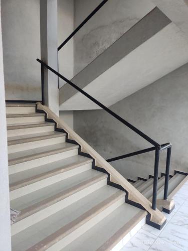 a set of stairs with black metal railing at Hotel Mextlitlán Tierra de Lunas in Zacatlán