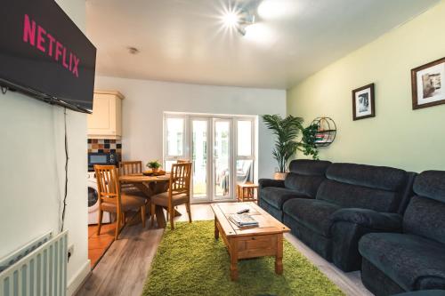 a living room with a couch and a table at Family Gathering Bungalow in Southampton