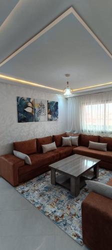 a living room with a couch and a table at La Maison Attawba in Beni Mellal