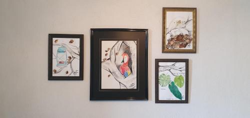 a group of framed pictures hanging on a wall at Gîte château d'Espalungue, piscine et SPA in Dognen