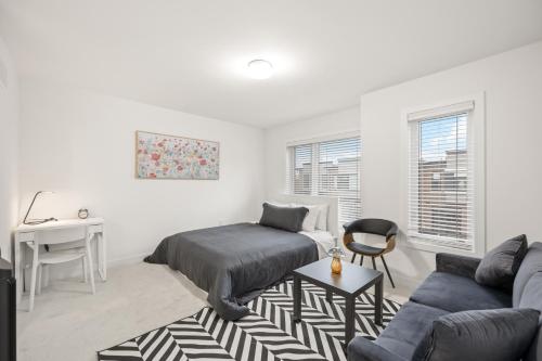 a bedroom with a bed and a desk and a couch at SPRUCE Private Suite with attached Full Bathroom in Toronto, Canada in Toronto
