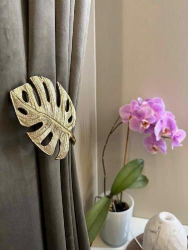 a butterfly sitting on a curtain next to a plant at Arctic feathers in Narvik