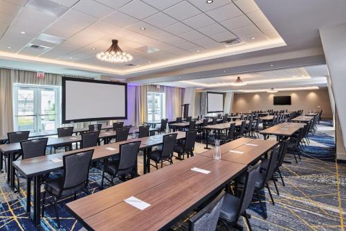 a conference room with tables and chairs and a projection screen at Residence Inn By Marriott Berkeley in Berkeley