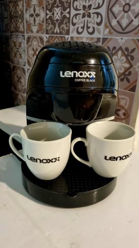 two cups of coffee are sitting on a toaster at Apart Hotel Copacabana in Rio de Janeiro