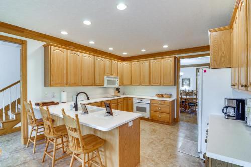 a kitchen with wooden cabinets and a kitchen island at Lake Cumberland Retreat with Deck and Views! in Jamestown
