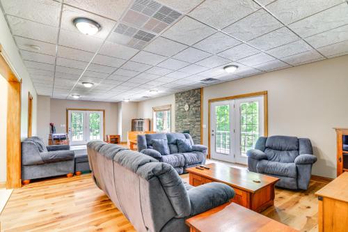a living room with couches and a table at Lake Cumberland Retreat with Deck and Views! in Jamestown
