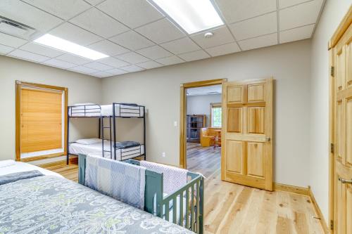 a bedroom with two bunk beds and a hallway at Lake Cumberland Retreat with Deck and Views! in Jamestown