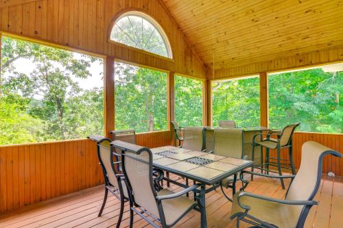 a screened in porch with a table and chairs at Lake Cumberland Retreat with Deck and Views! in Jamestown
