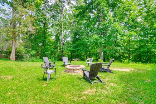 a group of chairs and a table in the grass at Lake Cumberland Retreat with Deck and Views! in Jamestown