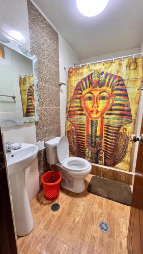 a bathroom with a toilet and a shower curtain at Miranda's House in Puerto Chicama