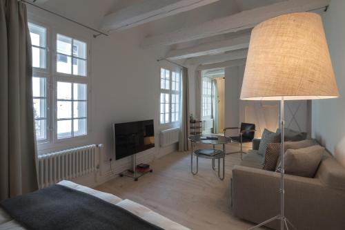 a living room with a couch and a table at Baseltor Hotel & Restaurant in Solothurn