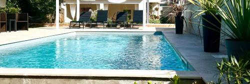 a swimming pool with blue water in a yard at Apartment Lucie3 in Biograd na Moru