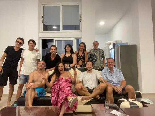 a group of people posing for a picture on a couch at Hostel K13 in Sarandë
