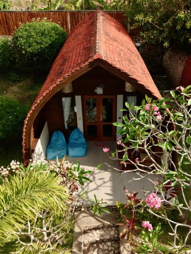 a dog house with blue pillows in a garden at Jungle Paradise in Nusa Penida