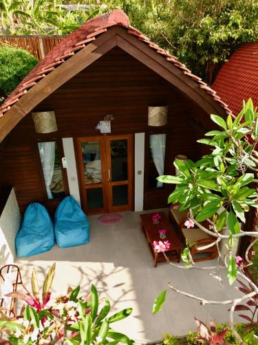a small dog house with blue pillows in a yard at Jungle Paradise in Nusa Penida
