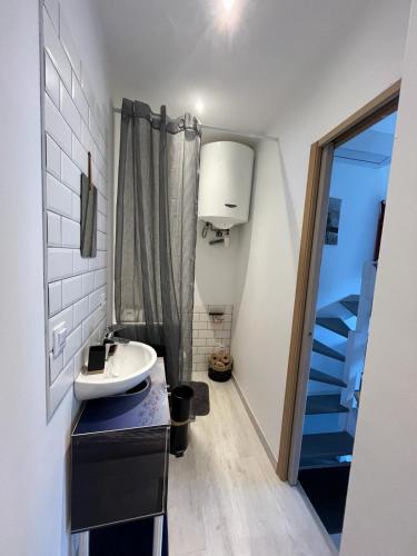 d'une petite salle de bains avec un lavabo et un escalier. dans l'établissement Chambre dans mas Centre-ville, à Perpignan