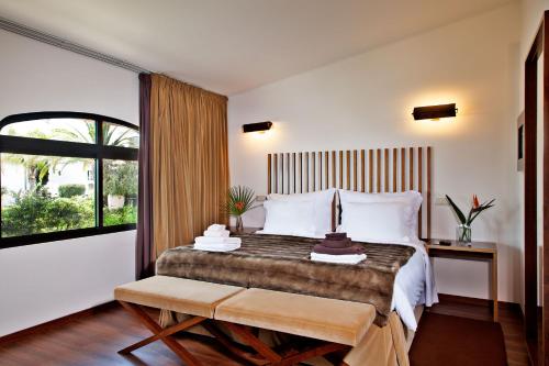 a bedroom with a large bed and a window at Sao Rafael Holidays in Albufeira