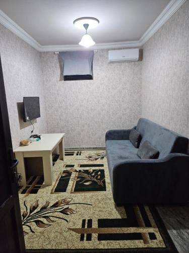 a living room with a couch and a table at Galstyans Hotel Zvartnots Airport in Pʼarakʼar