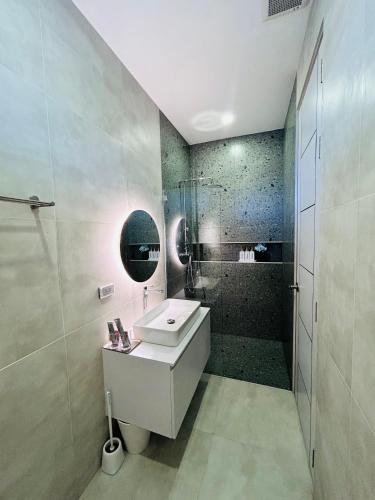 a bathroom with a sink and a shower at nanapoolvilla ruamchok in Chiang Mai