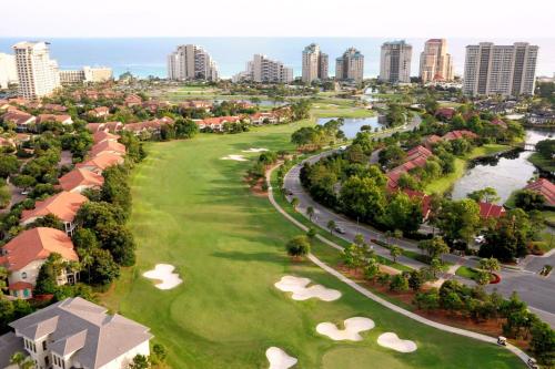 an aerial view of a golf course with a city at Hotel Effie Sandestin Resort, Autograph Collection in Destin