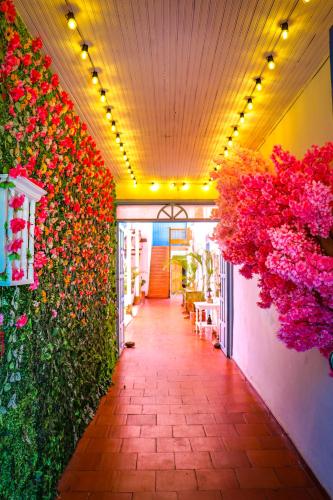a hallway with flowers on the side of a building at Aura Hotel Parque Barichara By Infinity in Barichara