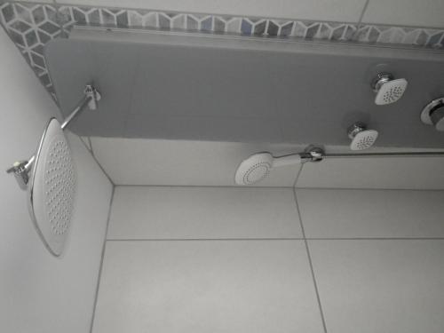 a bathroom with a shower with three shower heads at Ténorilo in Saint-Victor-sur-Loire