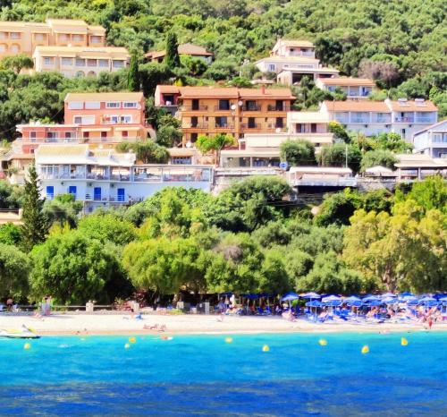 a group of people on a beach with houses at VASILIKI SeaMemories in Barbati