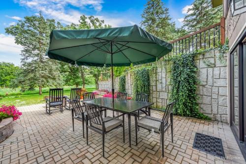 a patio with a table and chairs and an umbrella at Harmony Inn, Huntley Illinois in Huntley