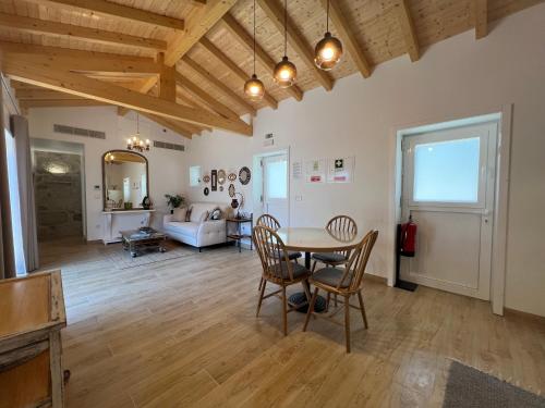 a large living room with a table and chairs at Eido de Bairros - Casa Cantinho da Touça in Soajo