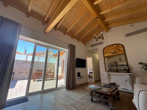 a living room with a couch and a mirror at Eido de Bairros - Casa Cantinho da Touça in Soajo