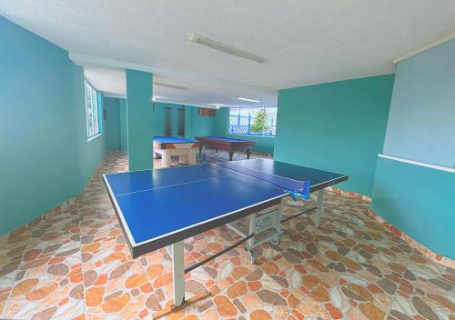 a ping pong table in a room with blue walls at VillaLoren in San Antonio del Tequendama