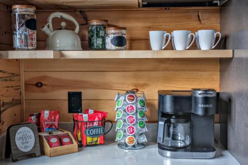 a coffee maker on a shelf with cups and other items at Our Black Bear Lodge in Gatlinburg