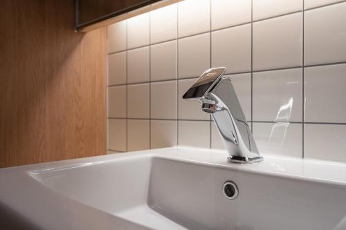 a white sink with a faucet on top of it at Brown Dot Hotel Sangju in Sangju