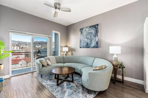 a living room with a couch and a table at Penthouse Apt - PoolGymHotTubPkg - View! in Salt Lake City