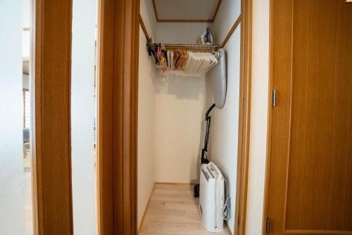 a hallway with a vacuum cleaner in a room at Lilac in Sapporo