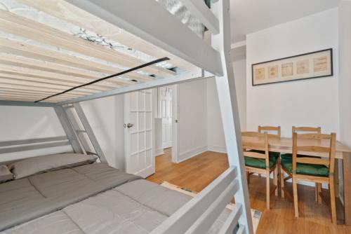 a bedroom with a bunk bed and a dining room at Close To Howard University , Unit #2 in Washington, D.C.