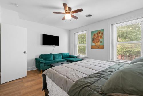 a bedroom with a green couch and a ceiling fan at Close To Howard University , Unit #2 in Washington, D.C.