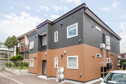 a house with a black and orange at Aphrodite in Hakodate